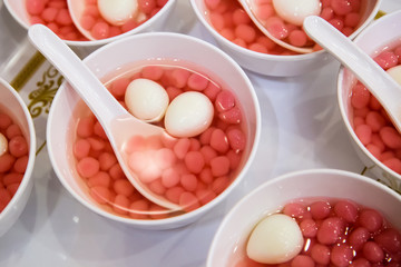 Chinese sweets dumpling from sticky rice, in syrup for serve wedding guest in wedding ceremony. image for article illustration and copy space.