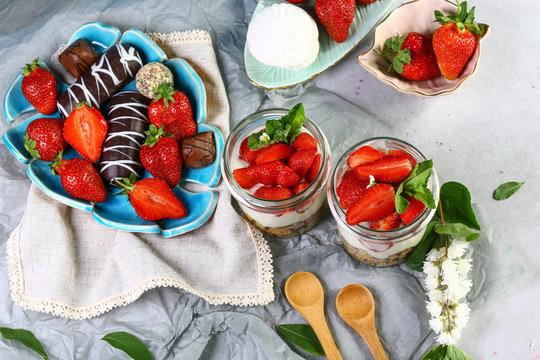 dessert Yogurt with fresh strawberry with chocolate cookies and candies. top view image with copy space