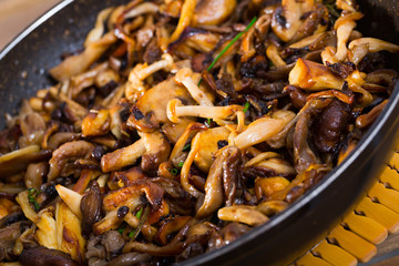 Fototapeta premium Mushrooms freshly fried in oil with onion