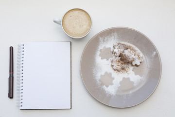 Holiday cookies and blank notepad background. Coffee Christmas mockup. Top view.