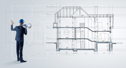 Architect watching a 2 dimension house plan
