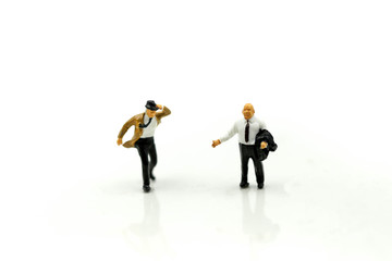 MIniature people : Businessman look a watch using for concept of time and Be Late For Something Day.