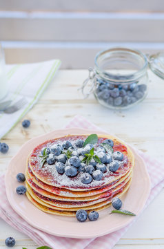 Vintage pancakes outside garden with blueberries