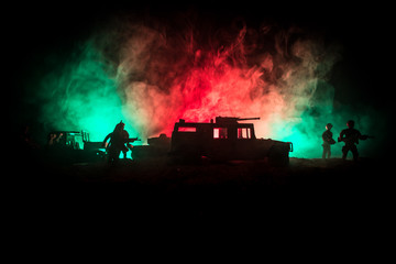 War Concept. Military silhouettes fighting scene on war fog sky background, World War Soldiers Silhouettes Below Cloudy Skyline At night. Attack scene. Army jeep vehicles with soldiers. army jeep