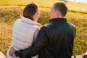 People, relations and feelings concept - young couple in love hugging in autumn park