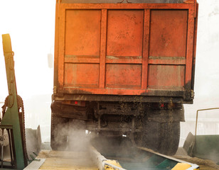 The truck unloads grain at the grain storage and processing plant, corn, trailer, unload seed