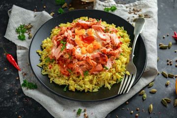 Traditional Indian-English kedgeree breakfast: basmati rice with egg benedict and hot smoked sweet chilli salmon.