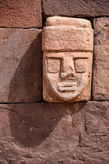 Fototapeta na wymiar Closeup of a carved stone tenonv head embedded in wall of at the Tiwanaku UNESCO World Heritage Site near La Paz, Bolivia