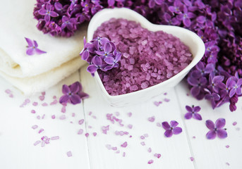 Fototapeta na wymiar Spa towel and massage products with lilac flowers