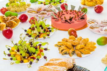 Served tables at the Banquet. Desserts, fruit and pastries on the buffet. Catering.