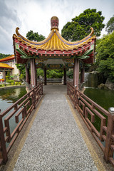 Fototapeta premium Shelter hut circus in the middle of the pond to rest under a hash sun light after crossing the little bridge or pathway
