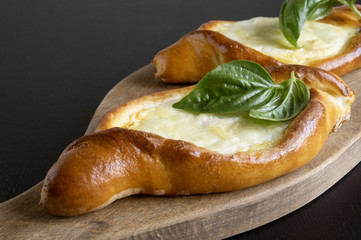 Homemade cakes, khachapuri with cheese and Basil.