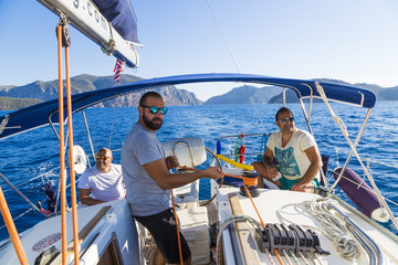 Three men hanging on the boat