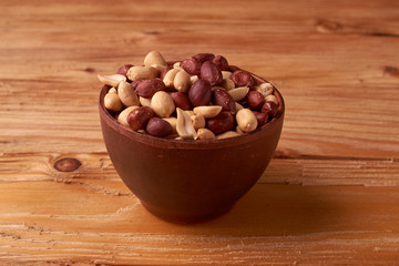 walnut peanut in clay bowl. peanuts for food textures. peanut harvest. fried peanuts. texture of the nuts. photo for layout. Copyspace