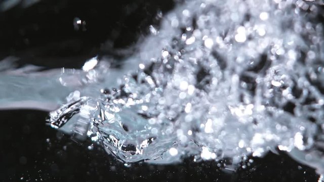Super slow-motion shot of water wave against black. Shooted with high speed cinema camera at 1000fps.