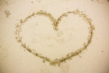 a heart in the sand on the beach. heart drawn on sand. 