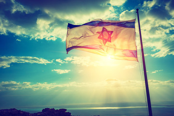 Flag of Israel against the morning sky. The Israeli flag on Masada