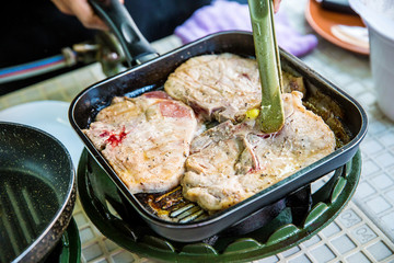 Pork steak are roasting on the pan. Pork Chop steak cooking process. high protein and calories food. Clean and lean food concept. image for background, wallpaper, objects and copy space.