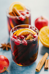 Mulled wine in glass on blue table