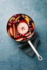 Mulled wine with fruits in saucepan