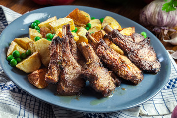 Roasted lamb chops served with baked potatoes