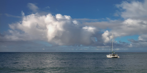 the yacht a catamaran at the coast of one of the islands of Seychelles