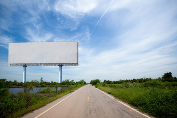 blank billboard on the sideway in the park. image for copy space, advertisement, text and object. white billboard in natural green.