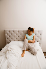 woman sitting on bed