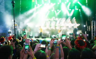 Use advanced mobile recording, fun concerts and beautiful lighting, Candid image of crowd at rock...