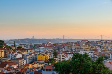 Lisbon, Portugal old town skyline with view on river Tagus and bridge on sunset