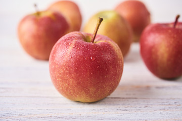 Fresh Juicy Ripe red apples on wooden white table