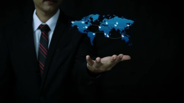 Asian Businessman using hologram virtual technology with visual effect Circle shape people icon and world map connection line for social network cyber futuristic technology concept with dark and grain