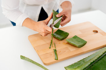 Woman preparing an aloe vera gel recipe with essences. Healthy, natural and cosmetic concept