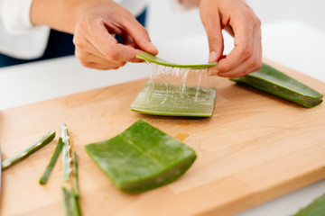 Woman preparing an aloe vera gel recipe with essences. Healthy, natural and cosmetic concept