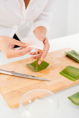 Obraz na płótnie Canvas Woman preparing an aloe vera gel recipe with essences. Healthy, natural and cosmetic concept