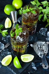 Alcoholic cocktail with rum, lime, mint and ice.