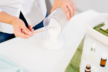 Woman preparing an aloe vera gel recipe with essences. Healthy, natural and cosmetic concept