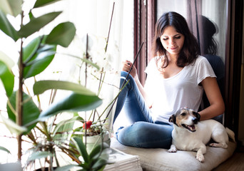 Pretty young woman stroking her dog