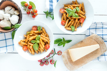 Penne pasta in tomato sauce with basil