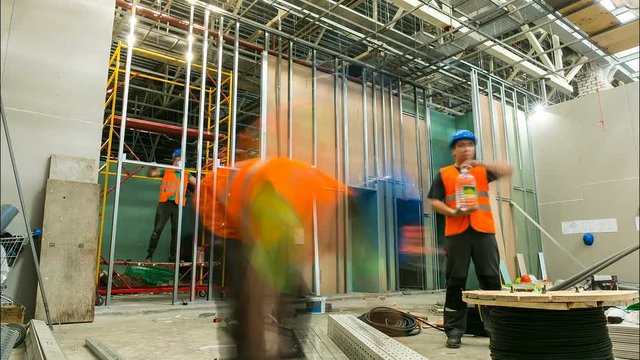 workers build inner walls with drywall sheets timelapse