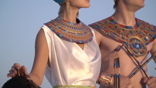 Grand Queen and Pharaoh of Egypt, next to a slave on her knees in desert