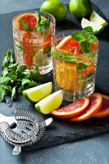 Citrus fruit cocktail with   mint in glass cup, selective focus