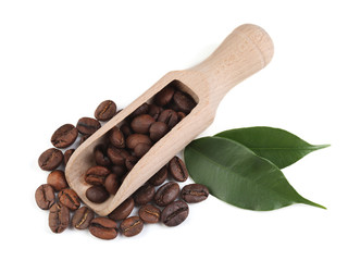 Coffee beans with scoop and leaves on white background
