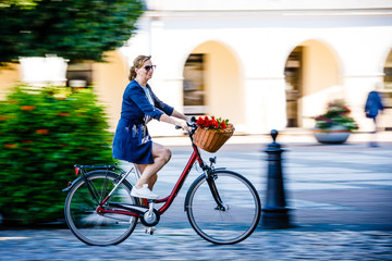 Urban biking - woman and bike on city street