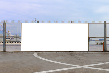 A blank billboard ready for new advertising on the harbor fence, big copy space © cristianstorto