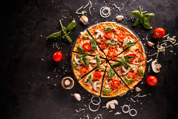 Tasty pizza with cherries, onions and mushrooms on a black background
