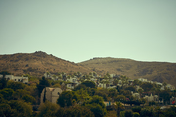 Fototapeta premium White houses on the slope of the mountains, the coast of the Aegean Sea of Turkey. Turgutreis , Bodrum.