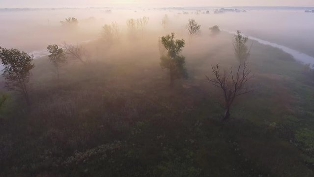 Aerial footage video of foggy morning. Flying over the Desna river. Sunrise time. Kyiv region, Ukraine.