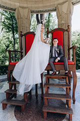 Walking newlyweds in nature. The bride and groom on the throne.