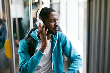 Man In Headphones Listening Music Riding In Transport